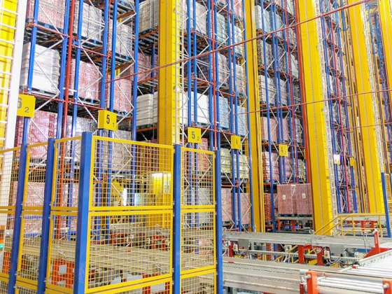 SSTC industrial automated storage and retrieval system AS/RS stacker crane operating in a high-bay warehouse