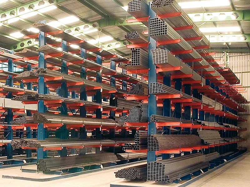 High-density mobile cantilever racking structure featuring robust vertical bracing, column anchors, and safety stops for industrial storage